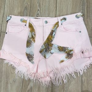 light pink stretchy denim shorts! adjustable tie. from altar’d state. size: 30